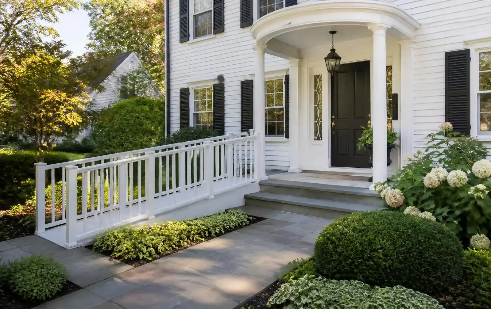 Accessible entrance and landscaped walkway at a classic Newton Colonial home