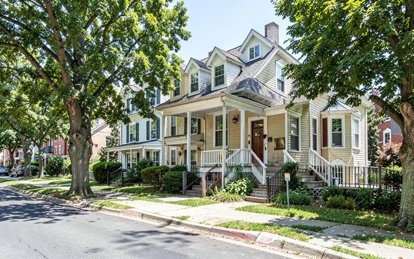 Residential street with colonial and two-family homes in Newtonville, MA