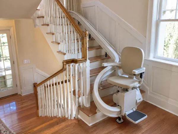 Curved stairlift rail following a staircase with an intermediate landing